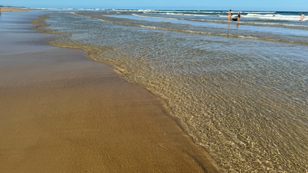 An almost abstract image of water over sand